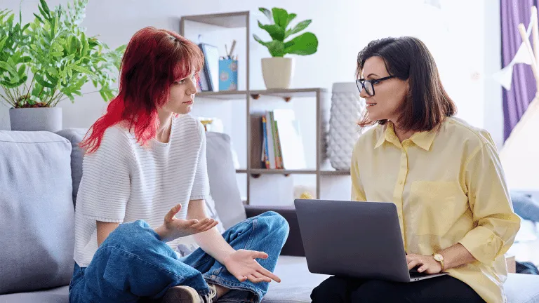 Therapy session for teenage girl, psychologist and patient together in office
